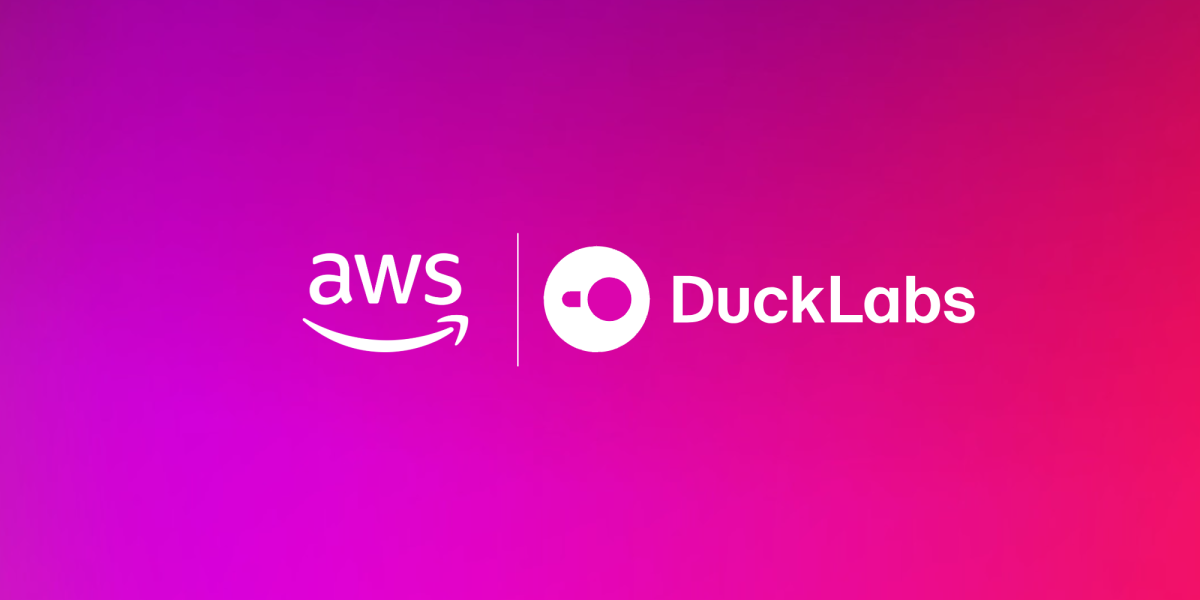 Official Amazon announcement graphic showing the AWS logo and the DuckLabs logo side by side in white on a magenta and pink gradient.