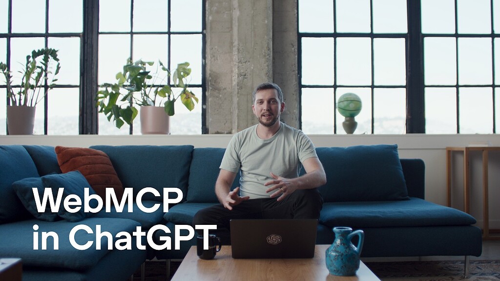 Title card from the OpenAI announcement video: a man sits on a blue sofa in a loft with tall windows and potted plants, a laptop open on the coffee table in front of him, with the words WebMCP in ChatGPT in large white type across the lower left.
