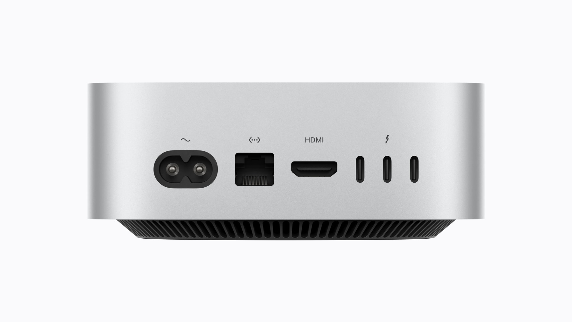 Official Apple photograph of the rear of the 2026 Mac mini showing three Thunderbolt ports, an HDMI port, an Ethernet jack and the power connector along the back edge of the silver aluminium chassis.