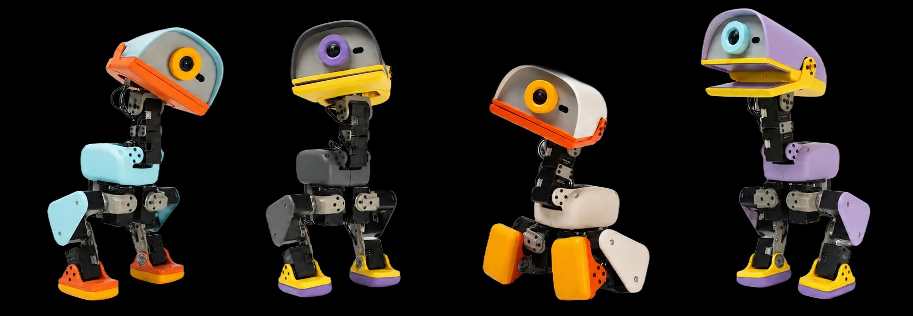 Four Microduck robots side by side in the Sky, Graphite, Cream and Lavender colourways, each with a large duck-bill head holding a camera lens above exposed black servo legs and coloured plastic feet.
