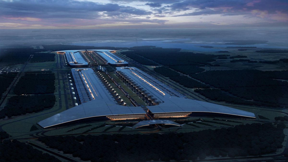 SpaceX render of the planned Terafab semiconductor complex in Grimes County, Texas, showing an extremely long low rectangular building stretching across flat open land under a clear sky.