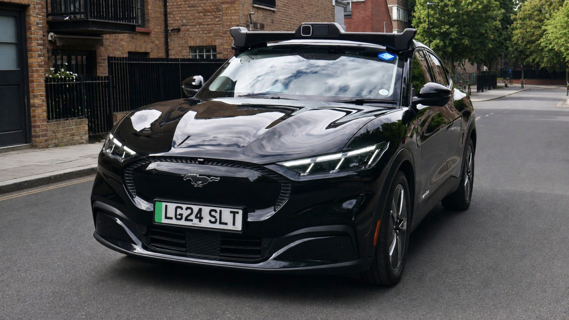 Wayve autonomous Ford Mustang Mach-E in Uber livery on a London street, from the Wayve announcement of its Transport for London private hire vehicle licences.