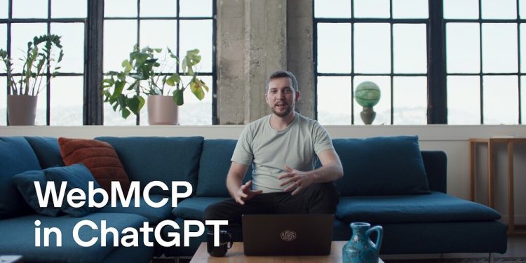 Title card from the OpenAI announcement video: a man sits on a blue sofa in a loft with tall windows and potted plants, a laptop open on the coffee table in front of him, with the words WebMCP in ChatGPT in large white type across the lower left.