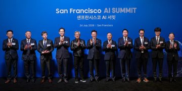 Official San Francisco AI Summit photograph dated 24 July 2026 showing eleven executives and officials applauding on stage in front of a blue backdrop.