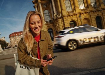 A Verne-branded white robotaxi driving past the Croatian National Theatre in Zagreb, from the Verne press material for Europe first commercial robotaxi service, which runs Pony.ai autonomous driving technology.