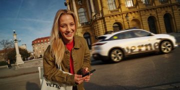 A Verne-branded white robotaxi driving past the Croatian National Theatre in Zagreb, from the Verne press material for Europe first commercial robotaxi service, which runs Pony.ai autonomous driving technology.