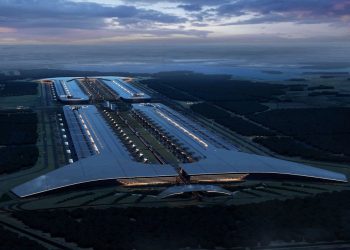 SpaceX render of the planned Terafab semiconductor complex in Grimes County, Texas, showing an extremely long low rectangular building stretching across flat open land under a clear sky.
