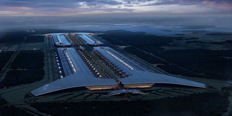 SpaceX render of the planned Terafab semiconductor complex in Grimes County, Texas, showing an extremely long low rectangular building stretching across flat open land under a clear sky.