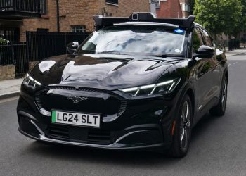 A Wayve autonomous Ford Mustang Mach-E in Uber livery on a London street, from the Wayve press release announcing that Transport for London granted private hire vehicle licences to its self-driving cars.