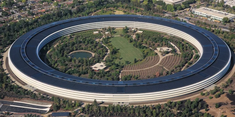 Aerial view of Apple Park, the circular Apple headquarters building in Cupertino, California, with its solar panel roof and central gardens
