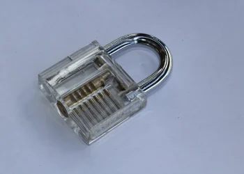 Transparent padlock for lockpicking training showing the internal pins and springs through its clear body