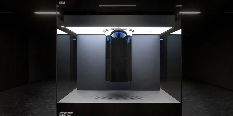 IBM Quantum System One quantum computer inside a glass enclosure in a dark room