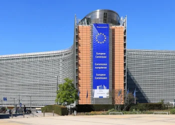 Berlaymont building in Brussels, seat of the European Commission, with a large blue European Commission banner on its central tower