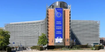 Berlaymont building in Brussels, seat of the European Commission, with a large blue European Commission banner on its central tower