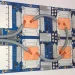 Photo of a Google Tensor Processing Unit 3.0 board with four chips, copper cold plates and grey coolant hoses