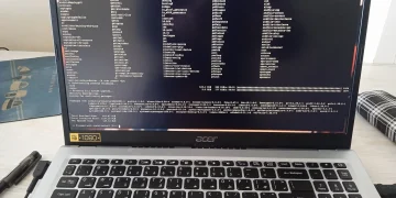 Acer laptop showing a full-screen Linux terminal where an Arch Linux system upgrade with sudo pacman -Syu is waiting for confirmation