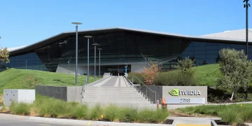 Entrance steps and glass facade of an Nvidia headquarters building in Santa Clara, California, next to an Nvidia sign