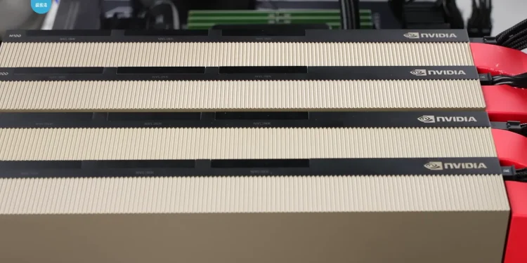 Four NVIDIA H100 GPU cards with gold heatsinks and NVLink connectors installed side by side in a test machine