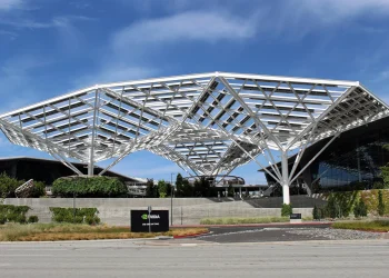 Nvidia headquarters in Santa Clara, California, with a large white steel canopy above the entrance and an Nvidia sign in the foreground