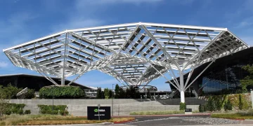 Nvidia headquarters in Santa Clara, California, with a large white steel canopy above the entrance and an Nvidia sign in the foreground