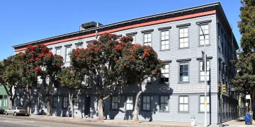 The Pioneer Building in the Mission District of San Francisco, a three-storey grey wooden building that houses the offices of OpenAI