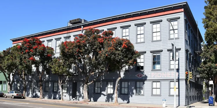 The Pioneer Building in the Mission District of San Francisco, a three-storey grey wooden building that houses the offices of OpenAI