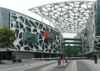 Alibaba Group headquarters in Hangzhou, a white building with a lattice facade and orange and green glass boxes