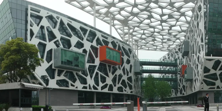 Alibaba Group headquarters in Hangzhou, a white building with a lattice facade and orange and green glass boxes