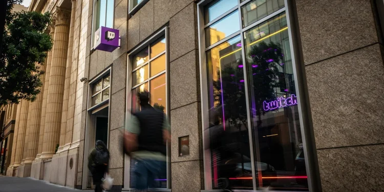 Street entrance of the Twitch headquarters building in San Francisco with the purple Twitch logo sign and a neon Twitch window sign